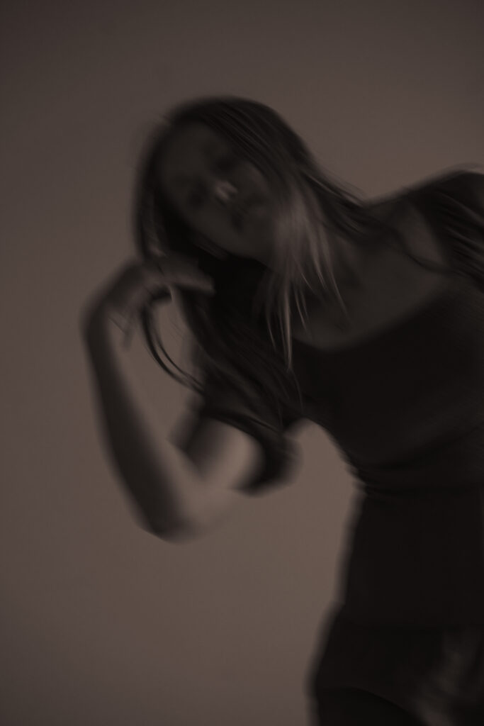 Slow shutter image of a ballerina dancing for portraiture.